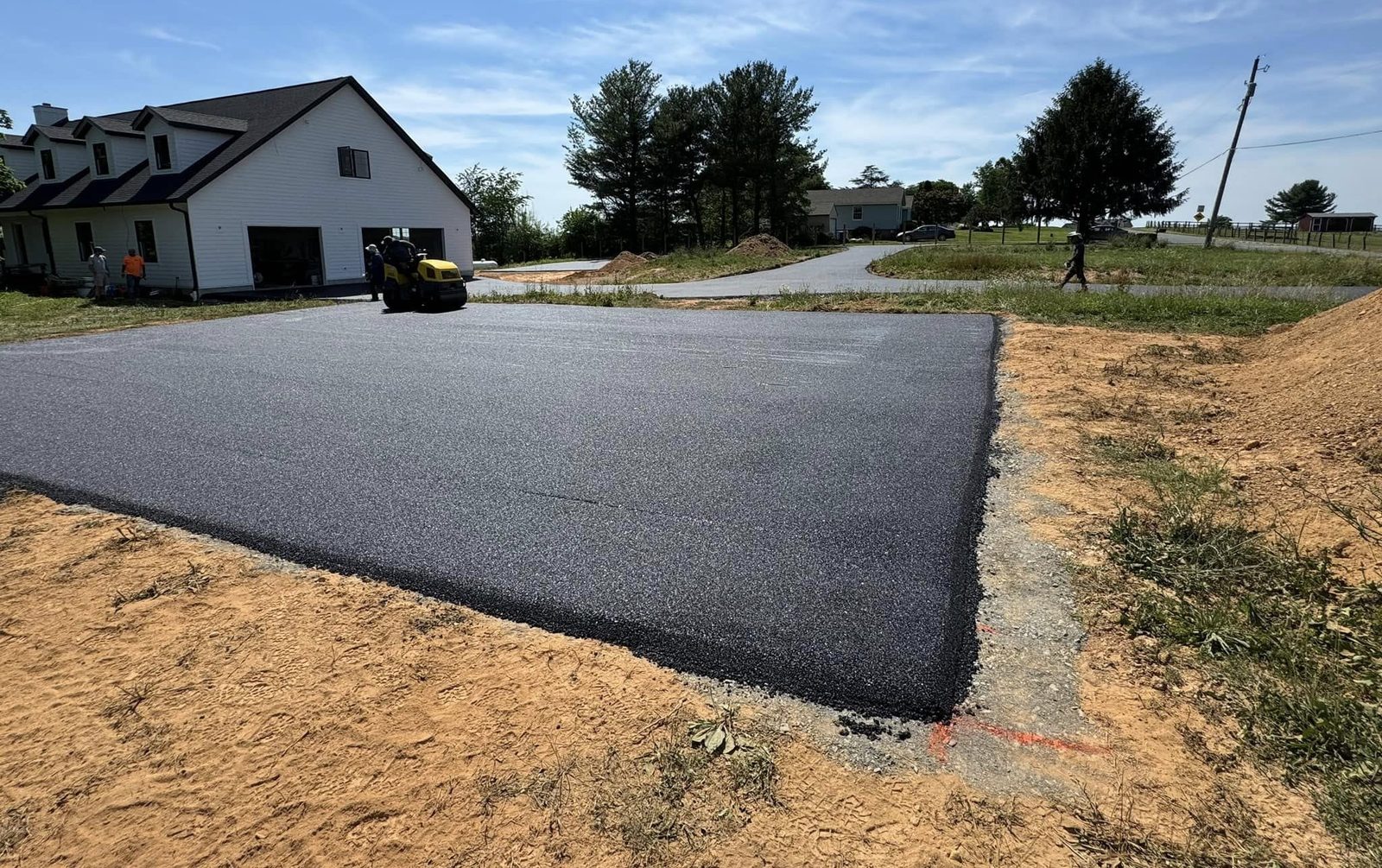 Fresh sealcoat application on an asphalt driveway by D&H Paving